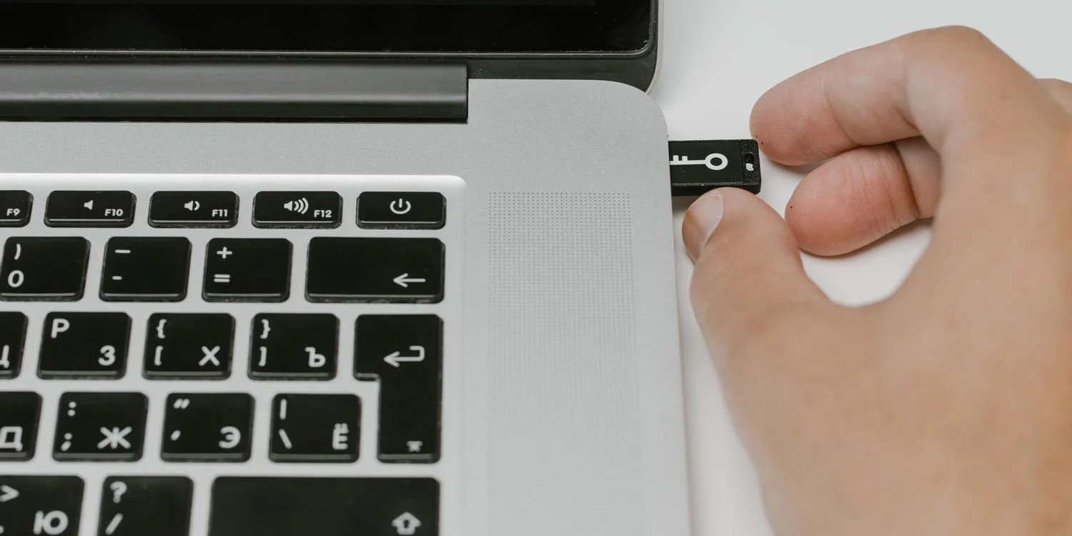 Close-Up-Image-of-a-Man-Inserting-USB-Drive-To-Laptop.webp